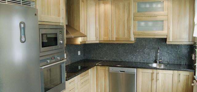 Contemporary dark kitchen with gold accents